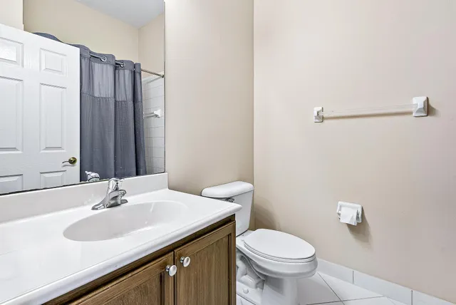a bathroom with a sink toilet and a mirror