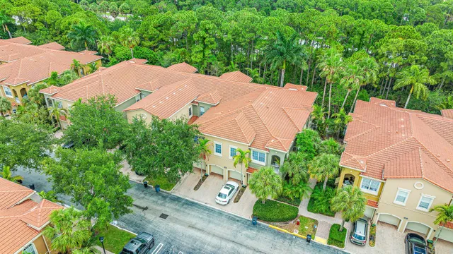 an aerial view of a house with garden space and street view