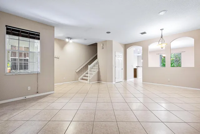 a view of a livingroom with an empty space and a window