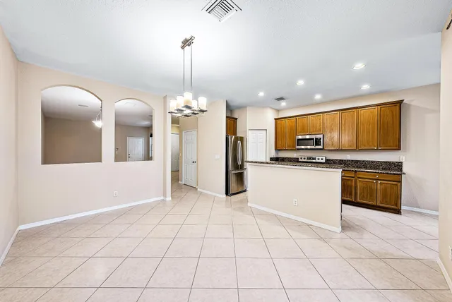 a view of a kitchen with microwave and refrigerator