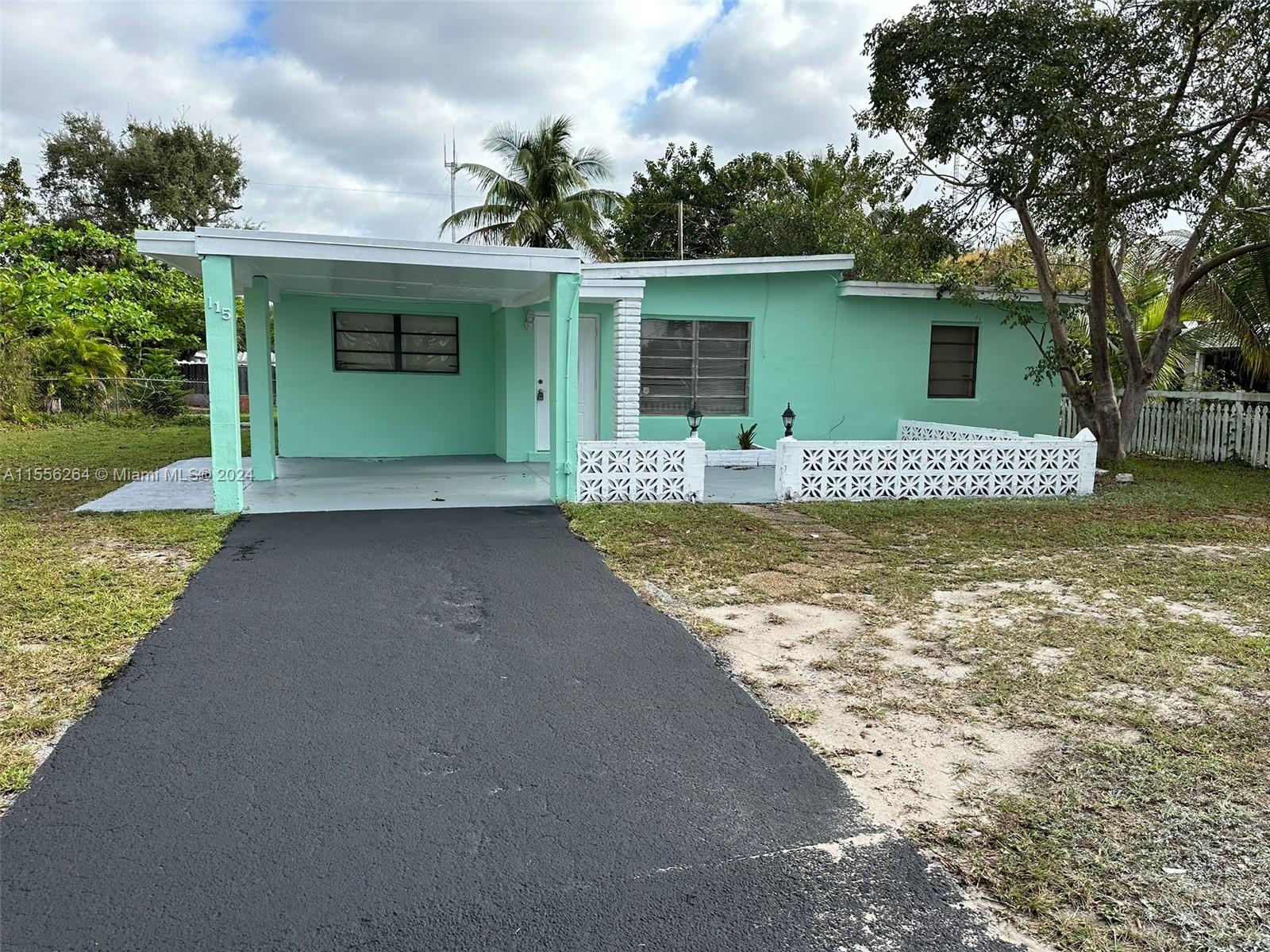 a front view of a house with a garden and yard
