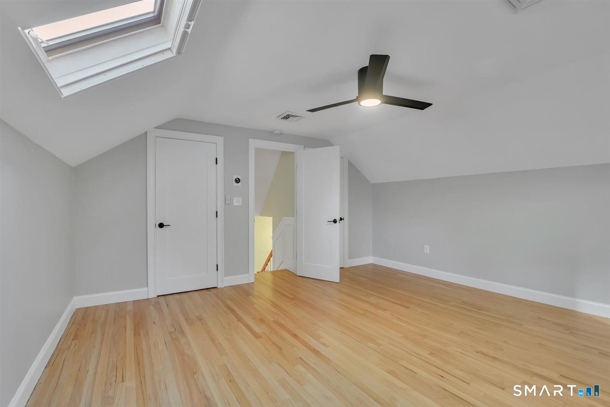 361 Miles Road Orange, CT 06477 - Photo 18 of 40 Just a few steps up, the upper level features hardwood flooring, a ceiling fan, skylight, and two large closets. This versatile space offers a third bedroom, bonus room, home office, or other flexible living space.