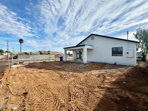a backyard of a house with shaded area