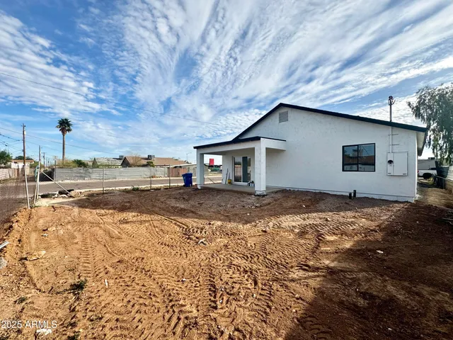 a backyard of a house with shaded area