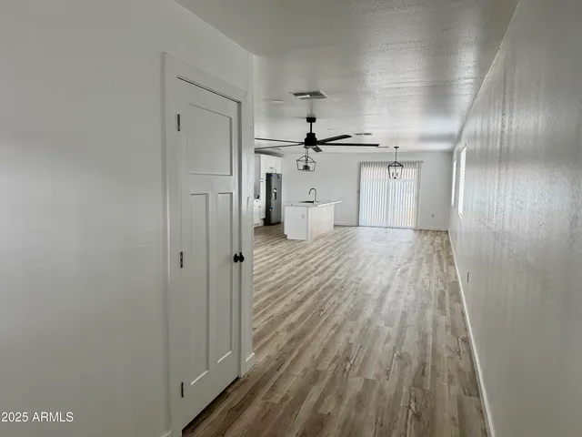 a view of a hallway with wooden floor
