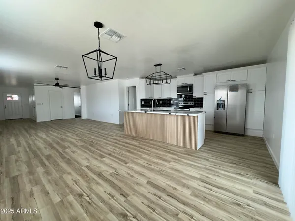 a kitchen with stainless steel appliances granite countertop a stove and a refrigerator