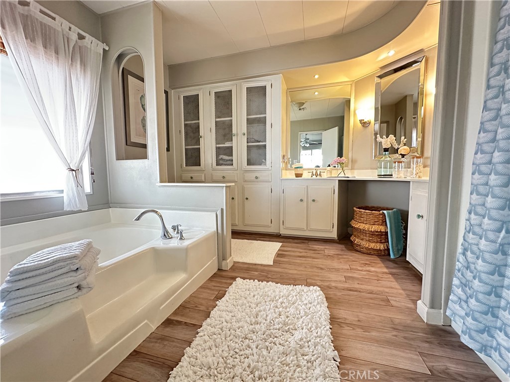 24701 Raymond Way, Unit 45 Lake Forest, CA 92630 - Photo 14 of 14 a spacious bathroom with a tub sink and mirror