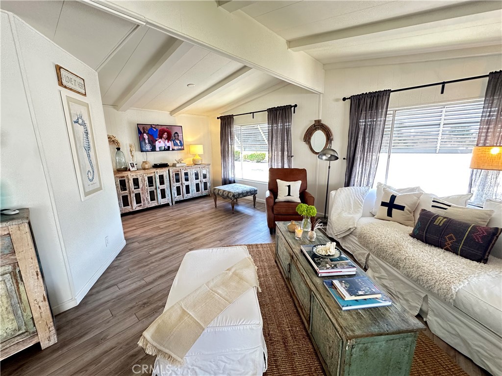 24701 Raymond Way, Unit 45 Lake Forest, CA 92630 - Photo 5 of 14 a living room with furniture a flat screen tv and a large window