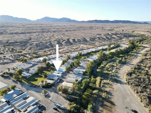 an aerial view of residential house and sandy dunes