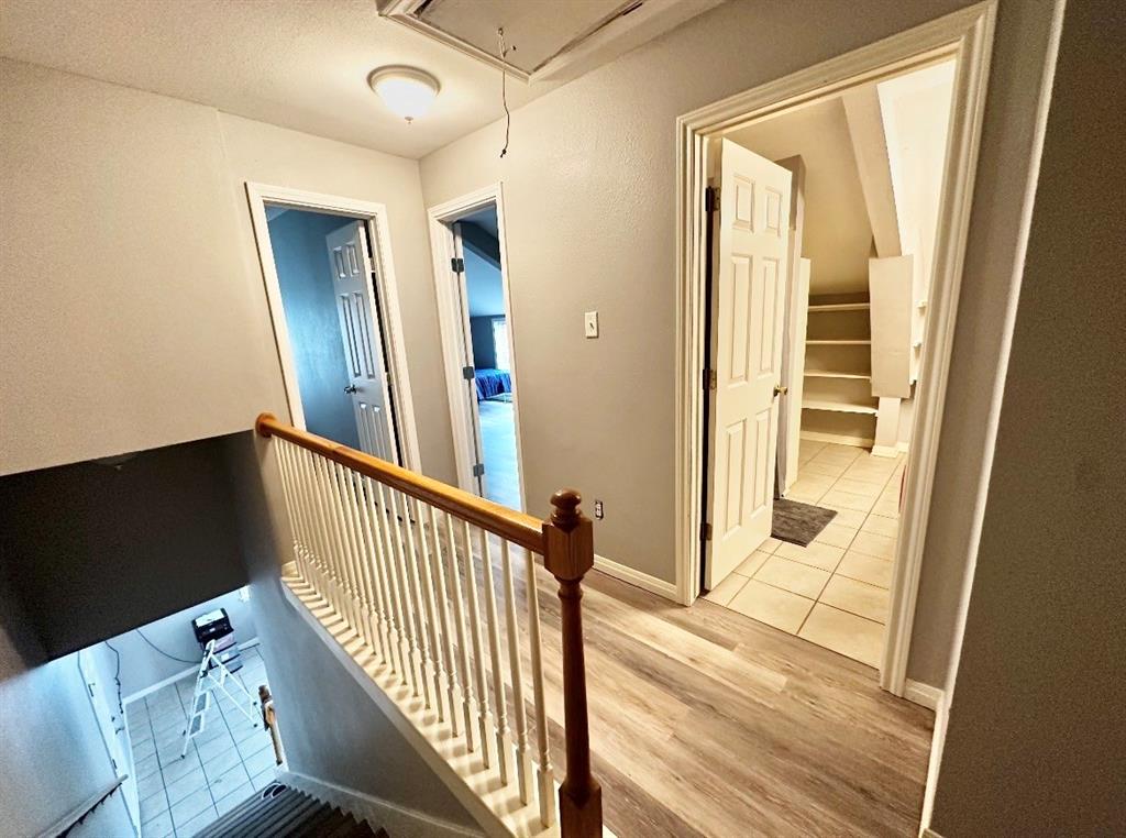 5205 Hudson Bend Road Austin, TX 78734 - Photo 16 of 21 a view of a hallway with wooden floor and staircase