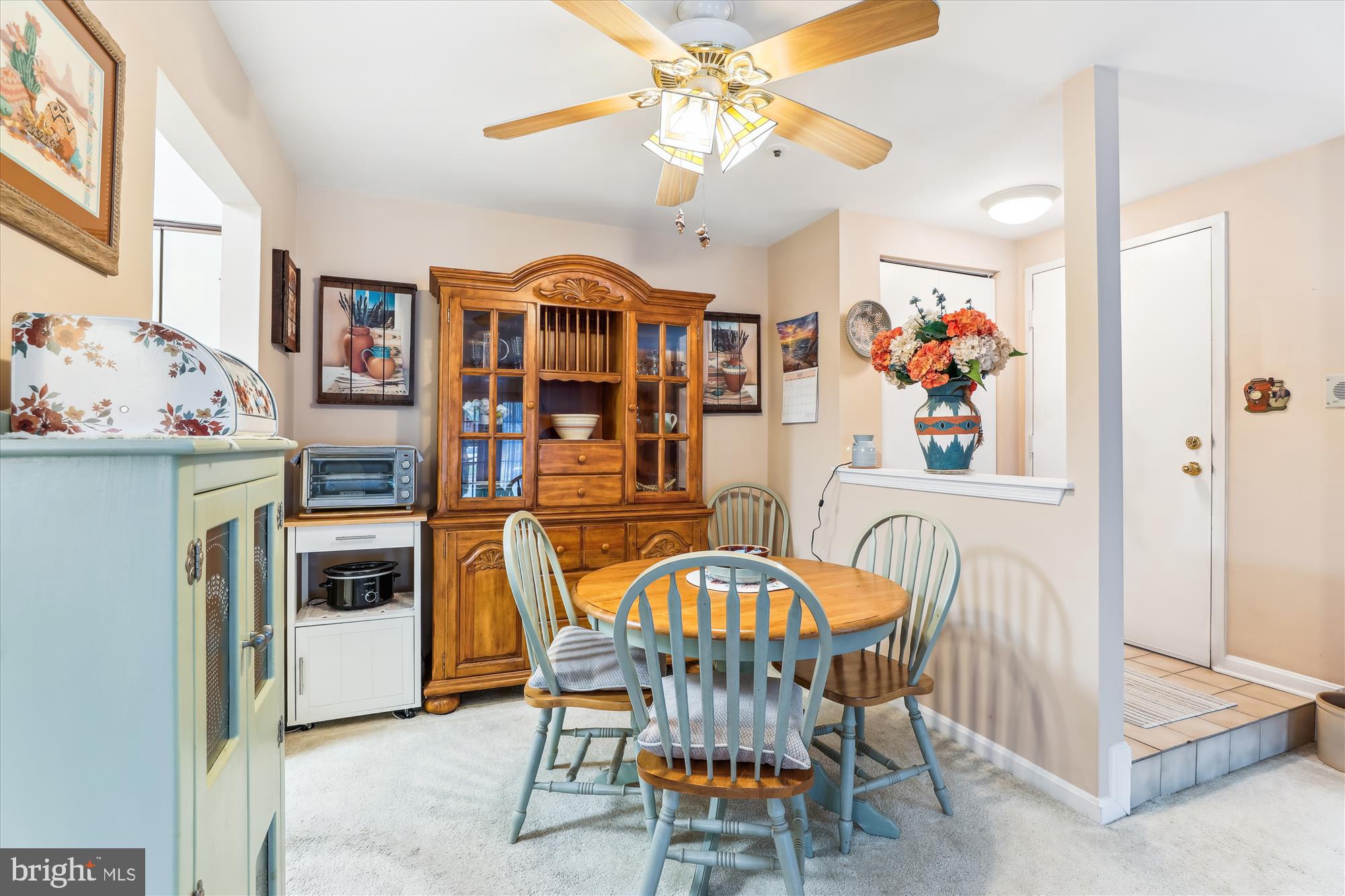 4912 Columbia Road, Unit 1 110 Columbia, MD 21044 - Photo 12 of 59 a dining room with furniture a chandelier and flat screen tv