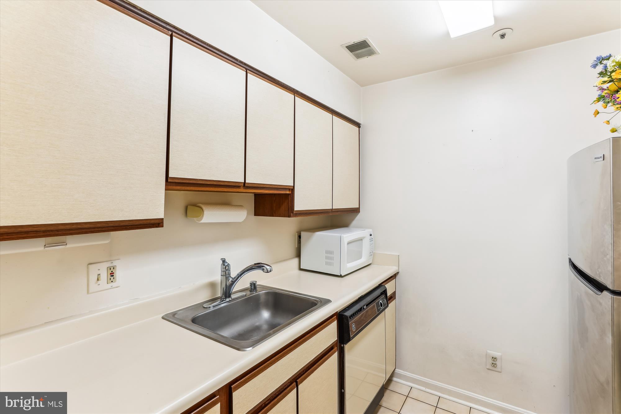 4912 Columbia Road, Unit 1 110 Columbia, MD 21044 - Photo 14 of 59 a kitchen with stainless steel appliances a sink dishwasher and cabinets next to a window