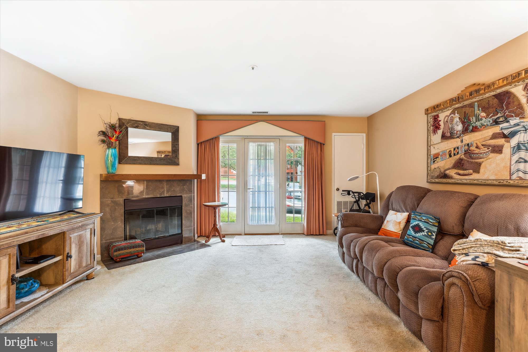 4912 Columbia Road, Unit 1 110 Columbia, MD 21044 - Photo 26 of 59 a living room with furniture a fireplace and a flat screen tv