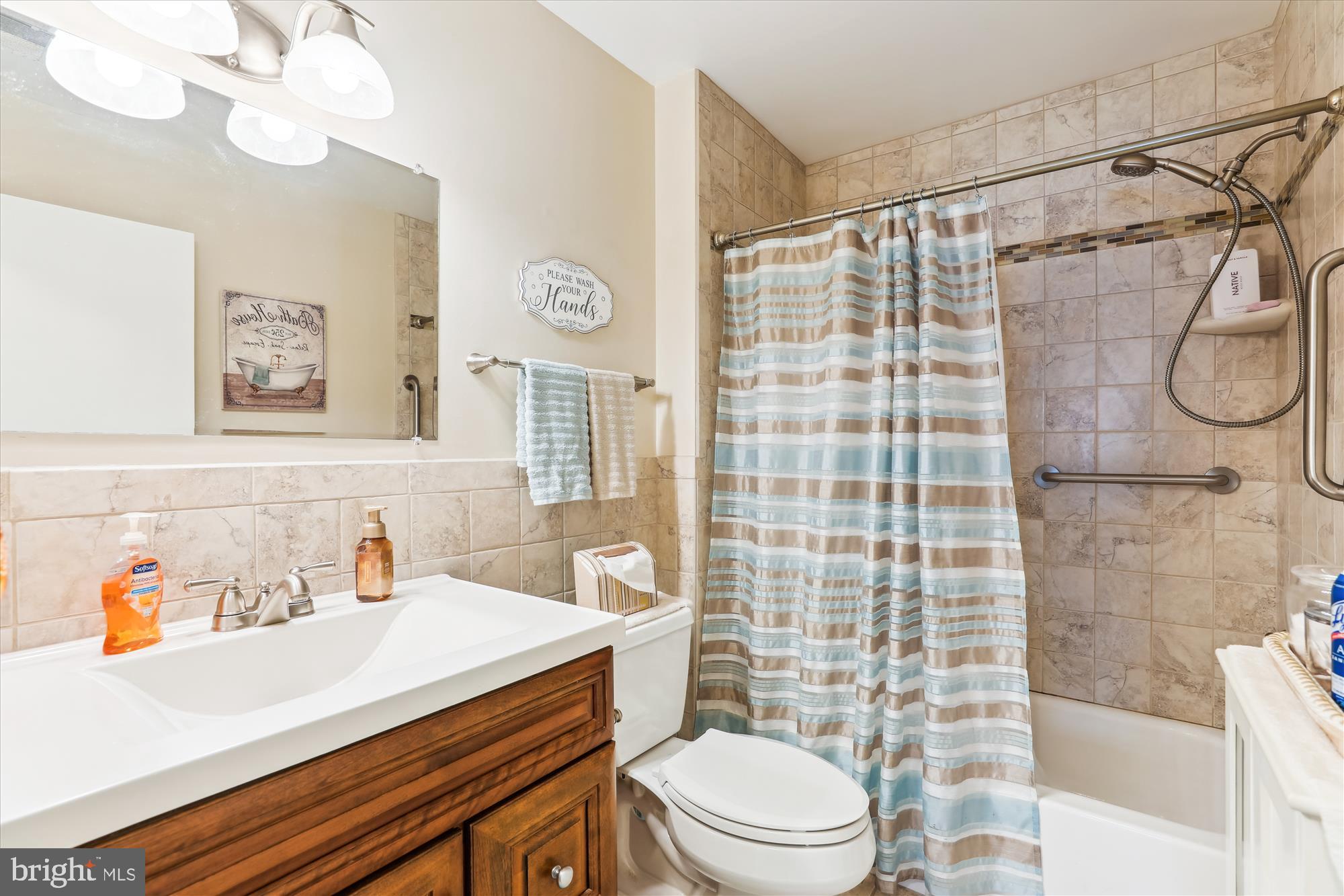 4912 Columbia Road, Unit 1 110 Columbia, MD 21044 - Photo 39 of 59 a bathroom with a sink a toilet and shower
