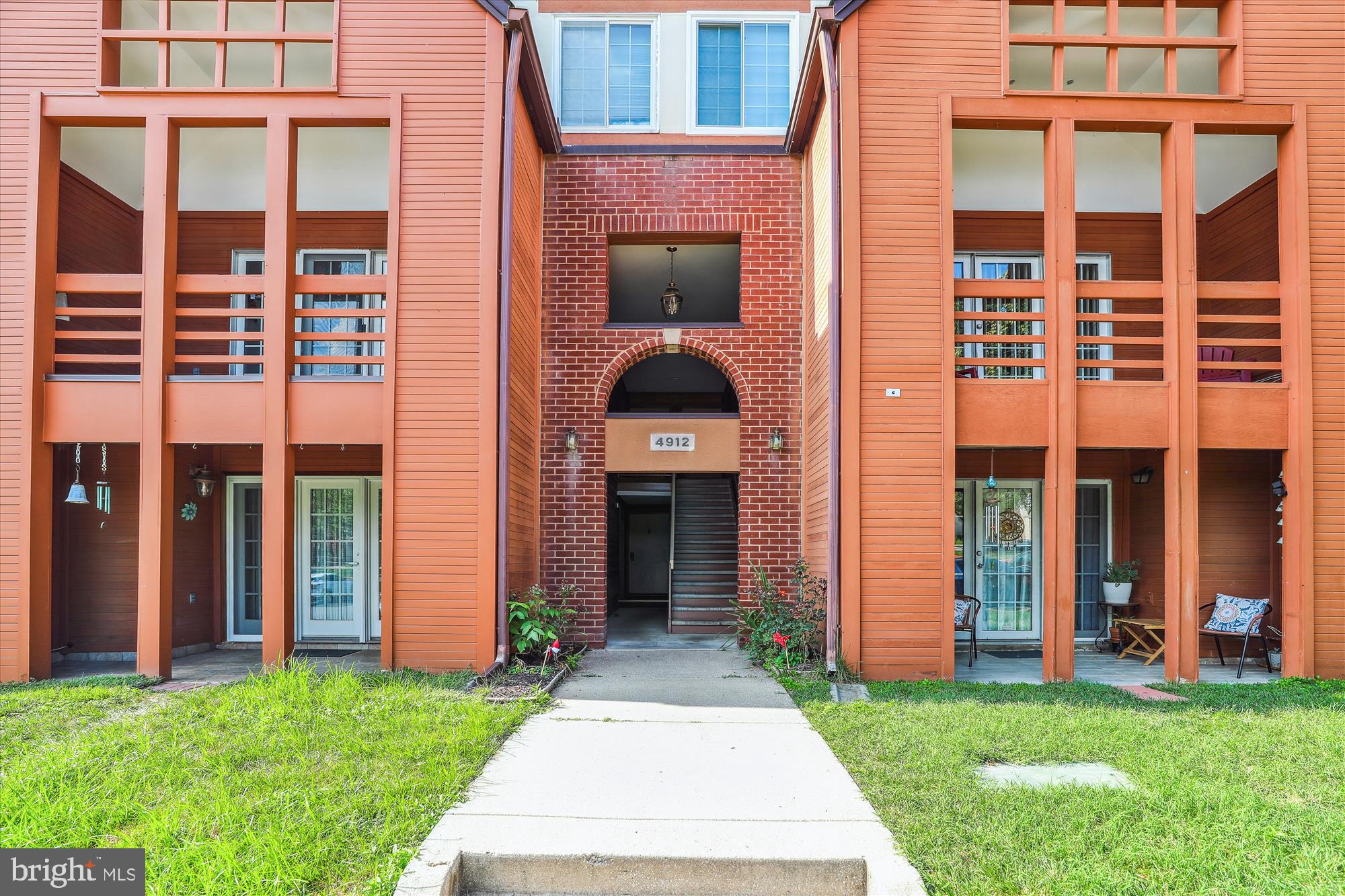 4912 Columbia Road, Unit 1 110 Columbia, MD 21044 - Photo 5 of 59 front view of a brick house with a yard