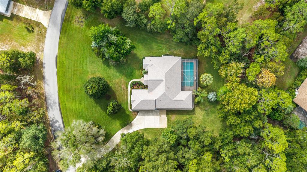 an aerial view of a house with a yard basket ball court and outdoor seating