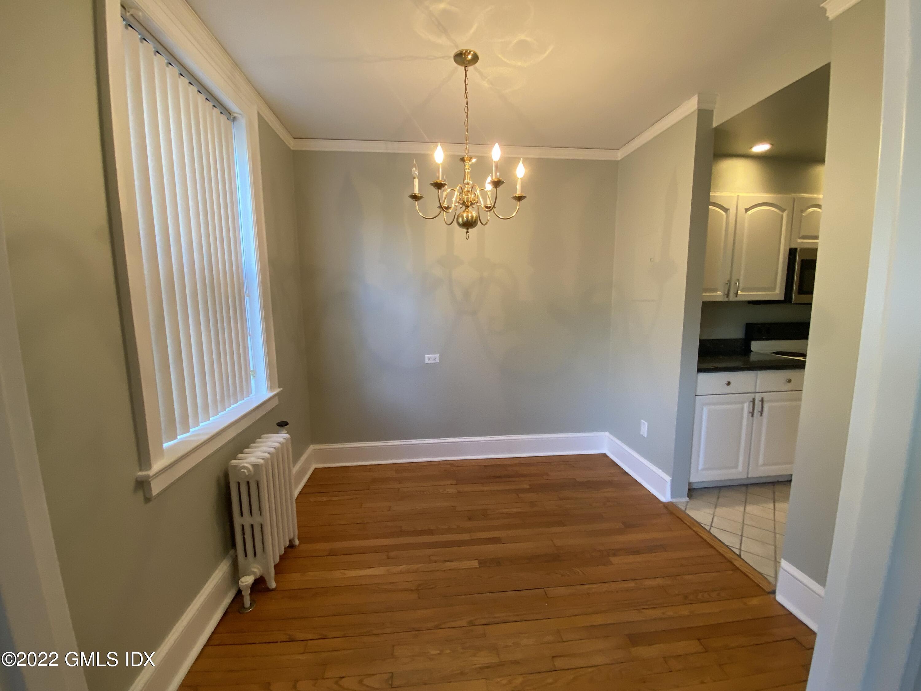169 Mason Street, Unit 1F Greenwich, CT 06830 - Photo 8 of 14 a view of a hallway with a chandelier