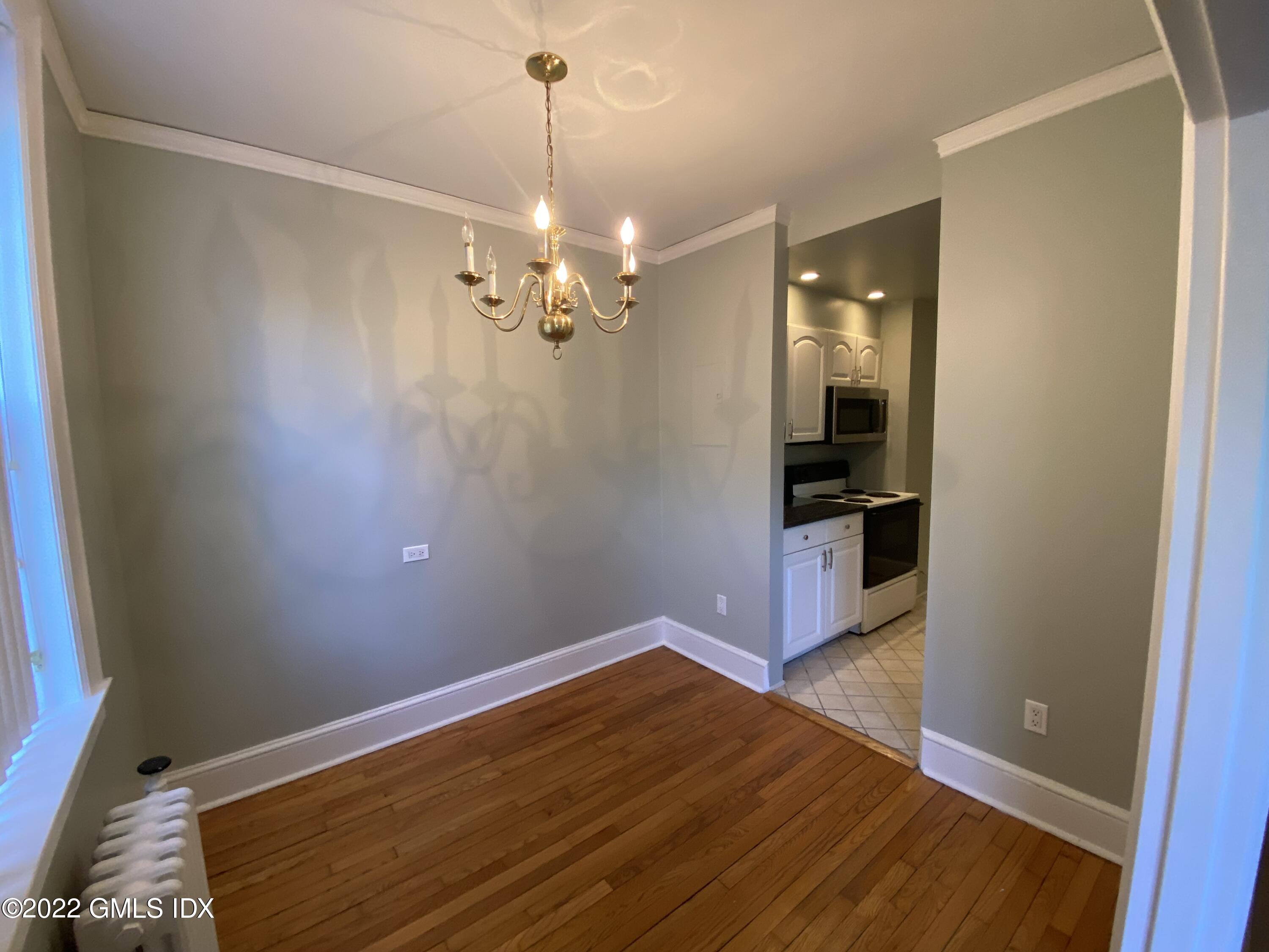 169 Mason Street, Unit 1F Greenwich, CT 06830 - Photo 9 of 14 a view of empty room with wooden floor