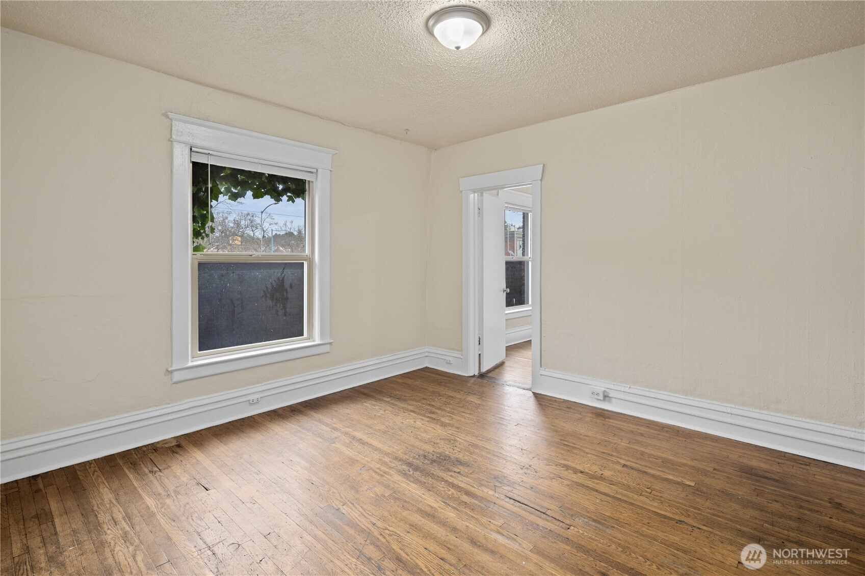 321 Broadway East Seattle, WA 98102 - Photo 21 of 38 an empty room with wooden floor and windows