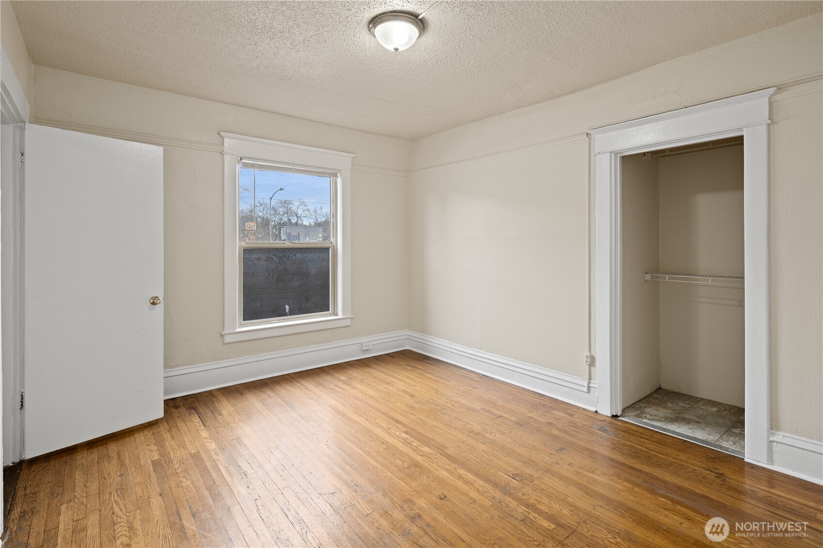 321 Broadway East Seattle, WA 98102 - Photo 29 of 38 an empty room with wooden floor and windows