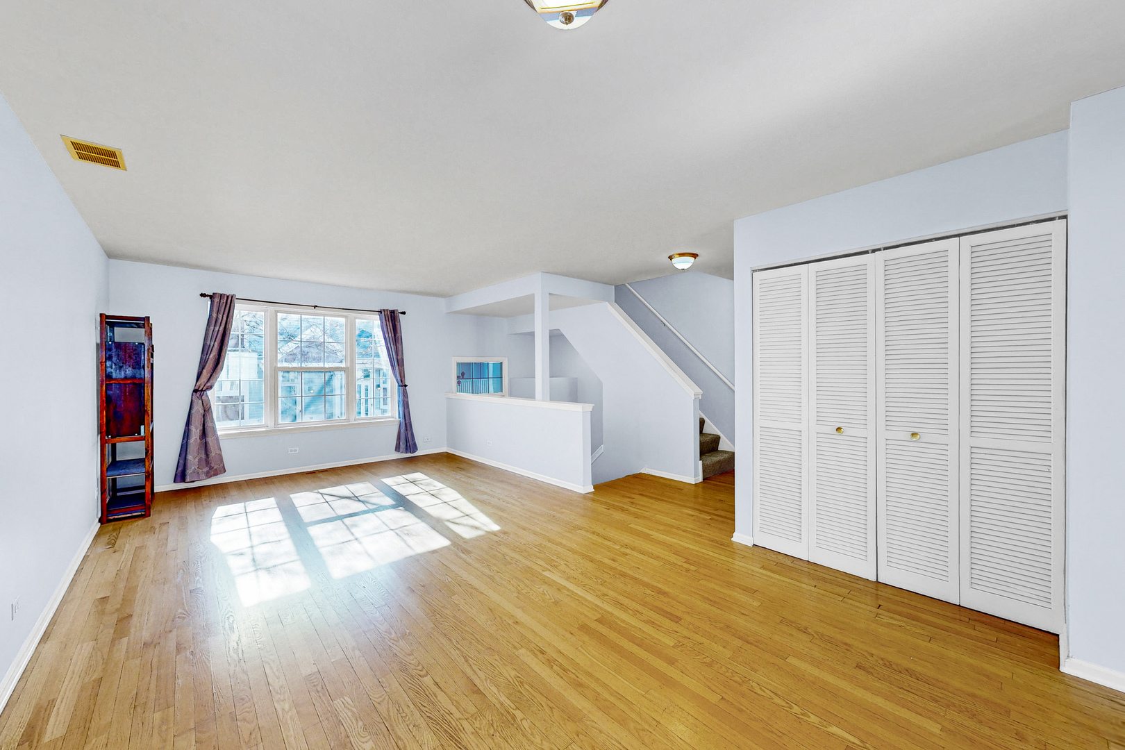 1645 Apple Tree Lane West Chicago, IL 60185 - Photo 3 of 20 a view of empty room with wooden floor and fan