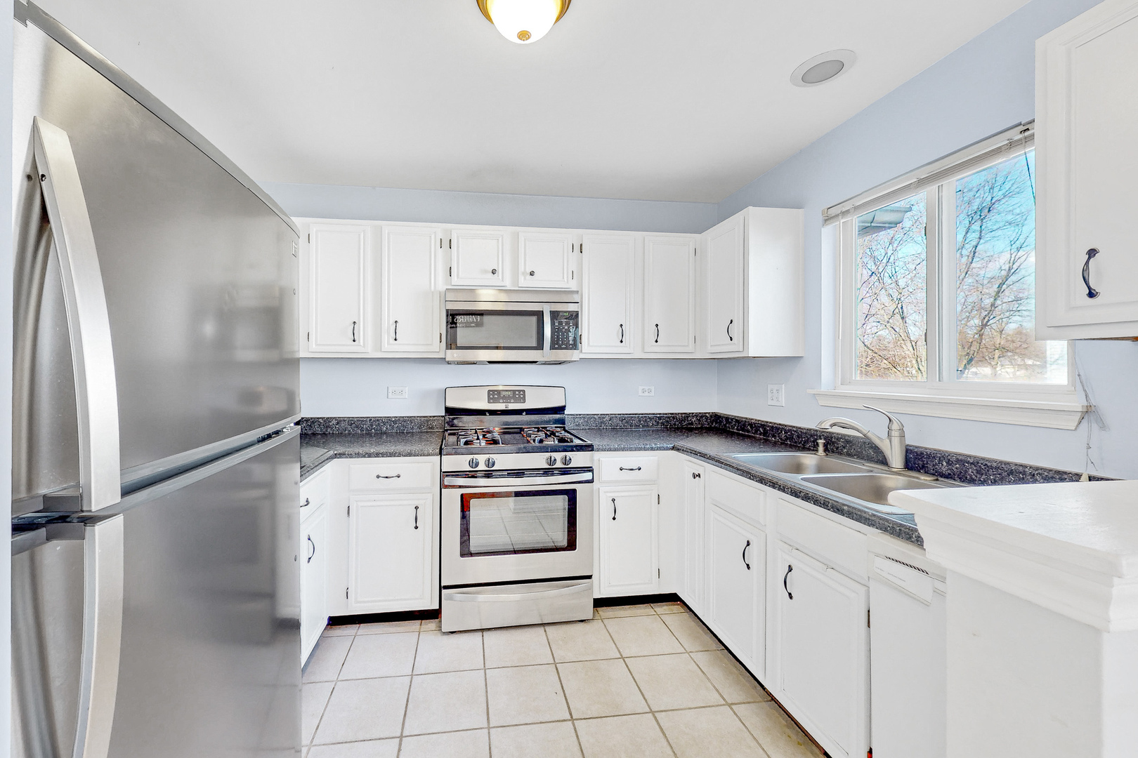 1645 Apple Tree Lane West Chicago, IL 60185 - Photo 4 of 20 a kitchen with stainless steel appliances granite countertop a sink stove and refrigerator