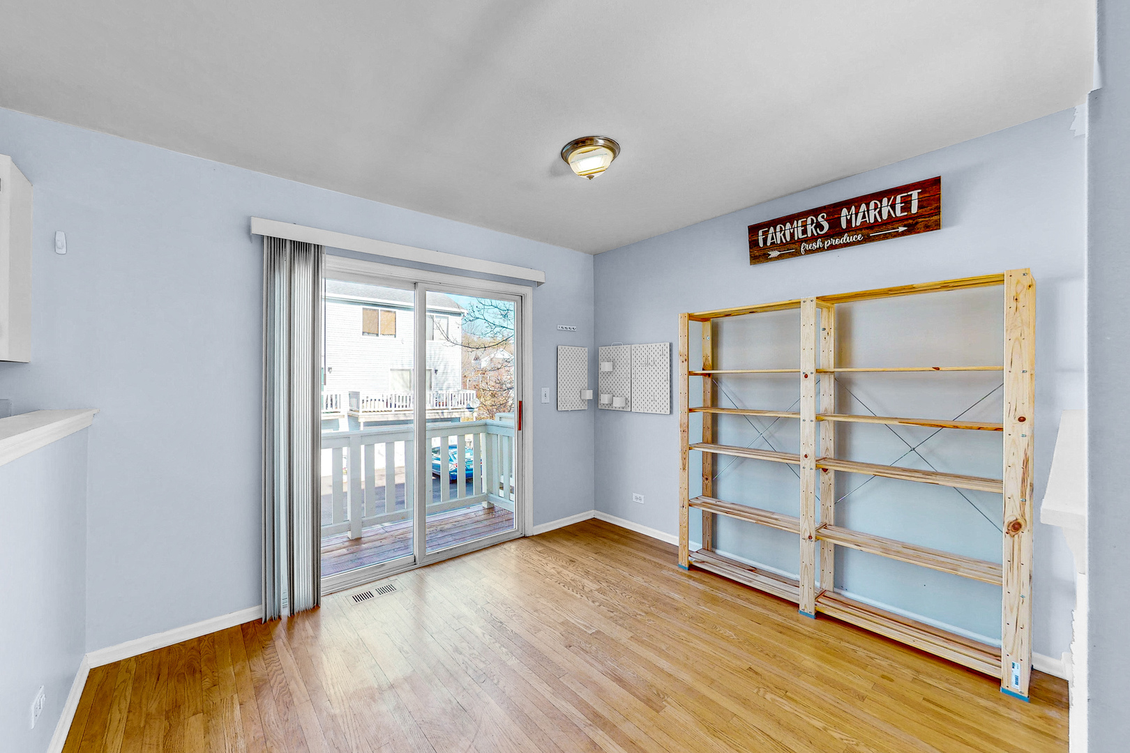 1645 Apple Tree Lane West Chicago, IL 60185 - Photo 6 of 20 a view of an empty room with wooden floor and a window
