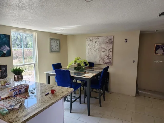 a view of a dining room with furniture and window
