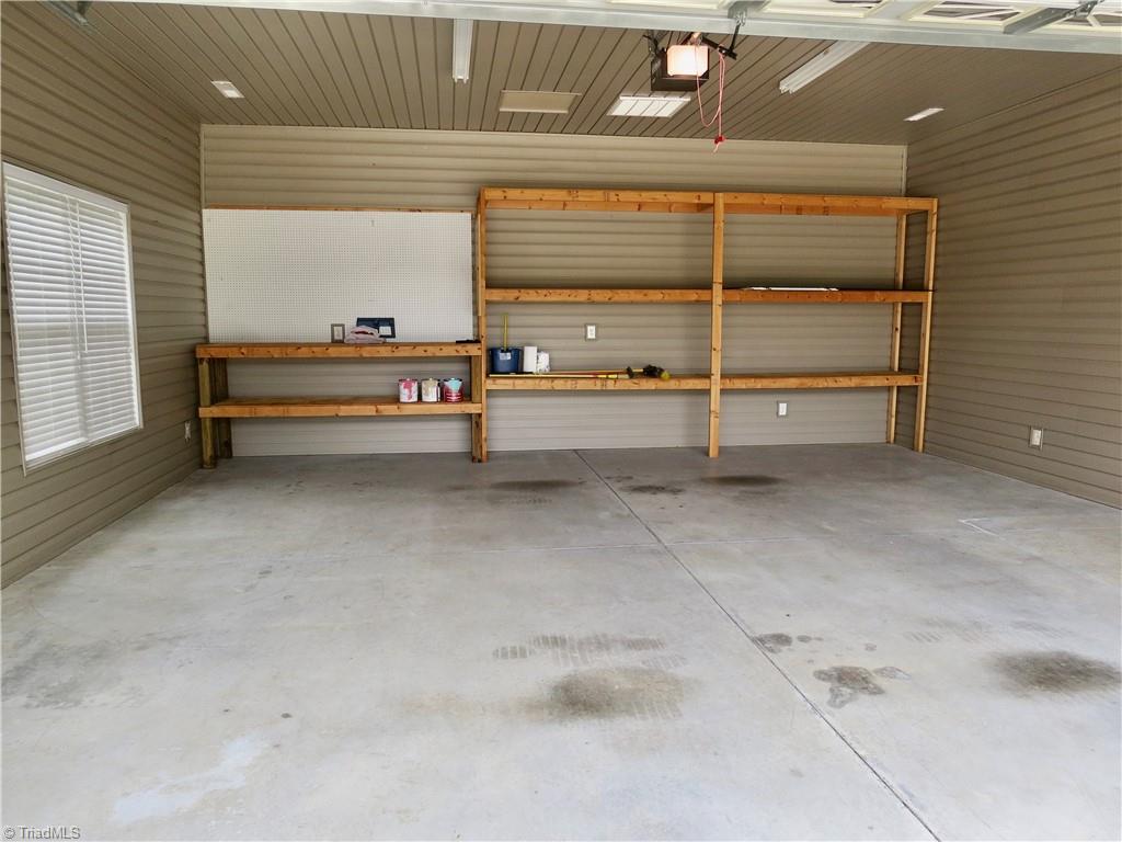 132 Feather Ridge Circle Reidsville, NC 27320 - Photo 35 of 42 Workbench and shelves in detached garage