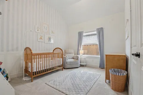a bedroom with furniture and a window