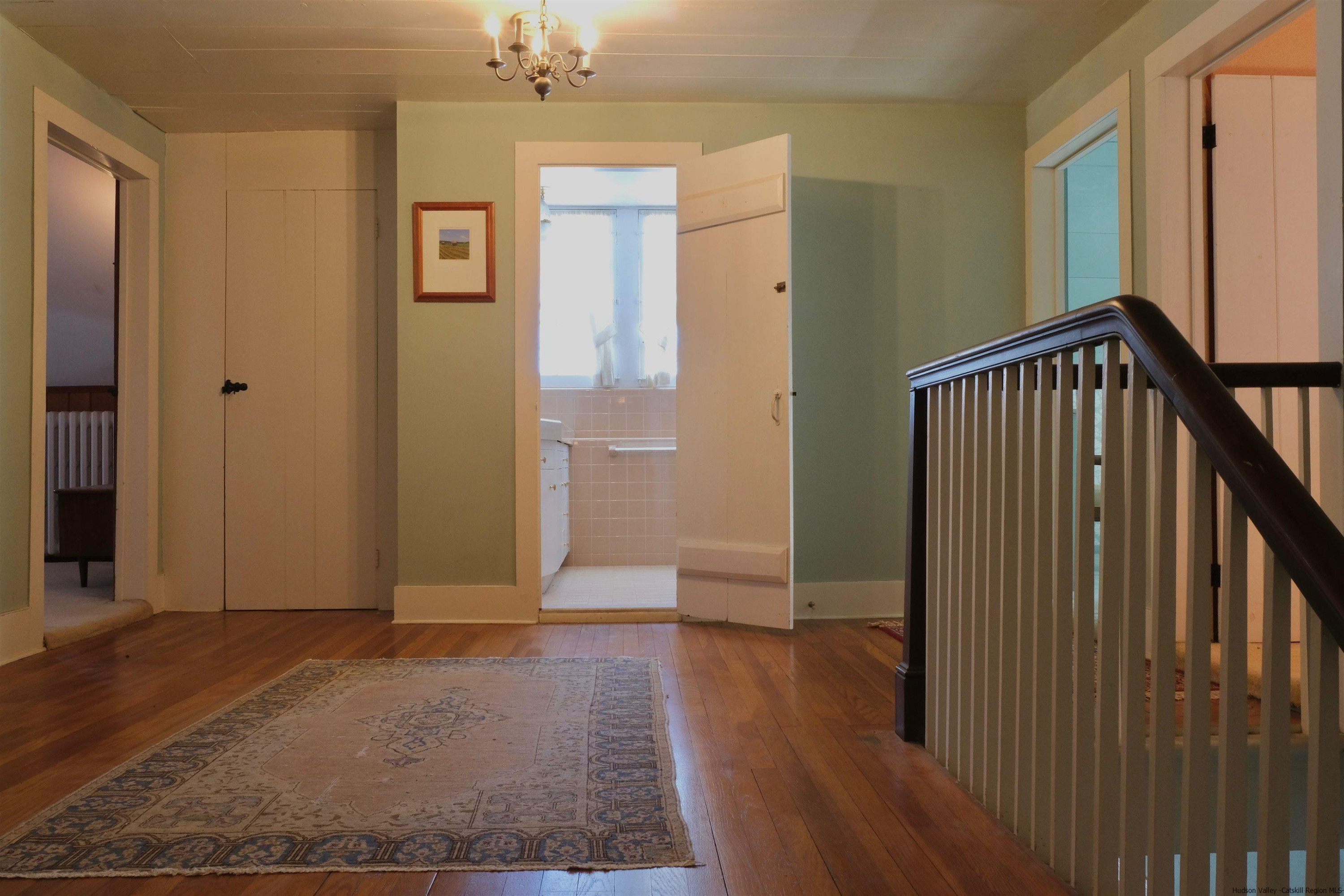 115 Buck Road Stone Ridge, NY 12484 - Photo 19 of 35 a view of a hallway with wooden floor and staircase