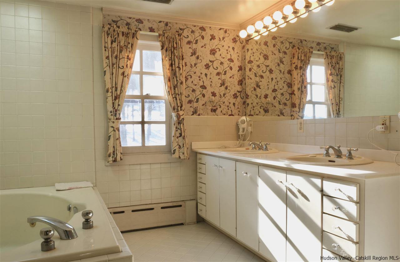 115 Buck Road Stone Ridge, NY 12484 - Photo 21 of 35 a bathroom with a sink and a mirror