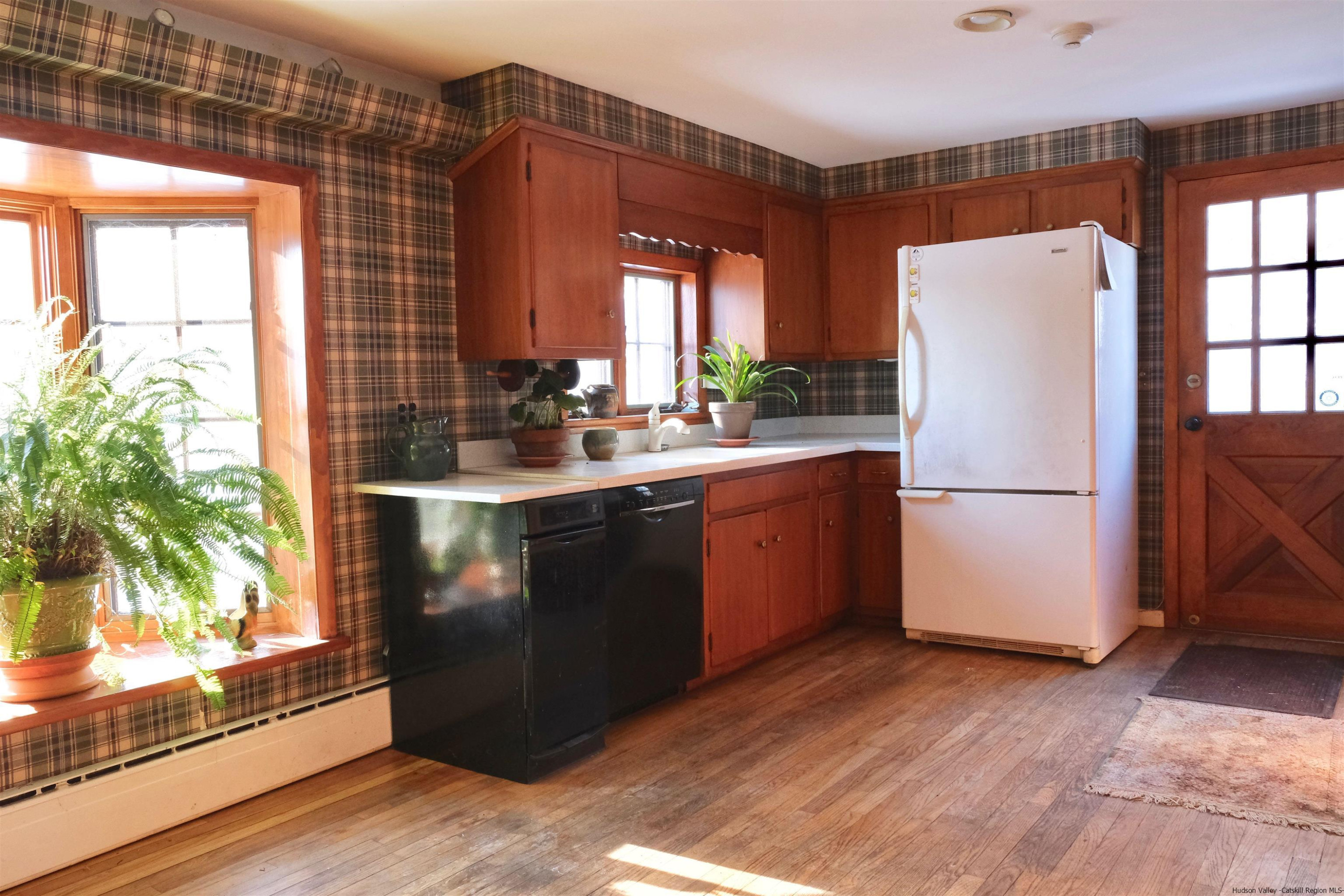 115 Buck Road Stone Ridge, NY 12484 - Photo 26 of 35 a kitchen with a refrigerator and a sink