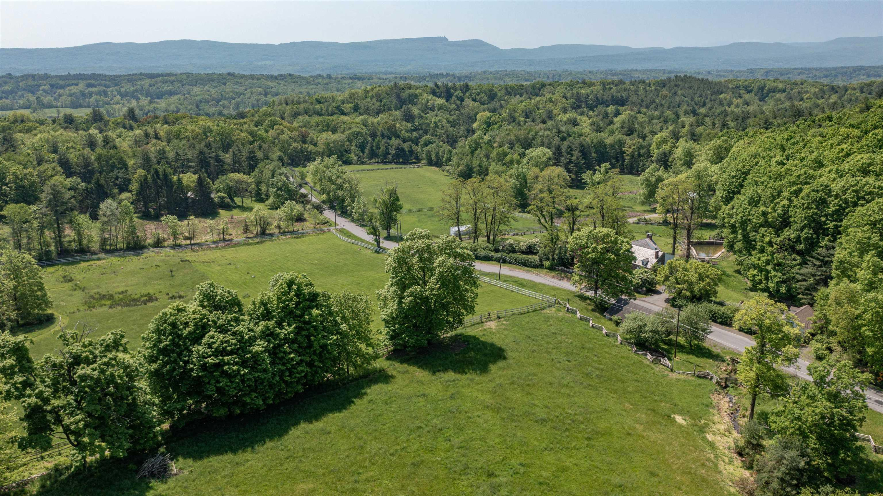 115 Buck Road Stone Ridge, NY 12484 - Photo 32 of 35 a view of a lush green field with mountains in the background