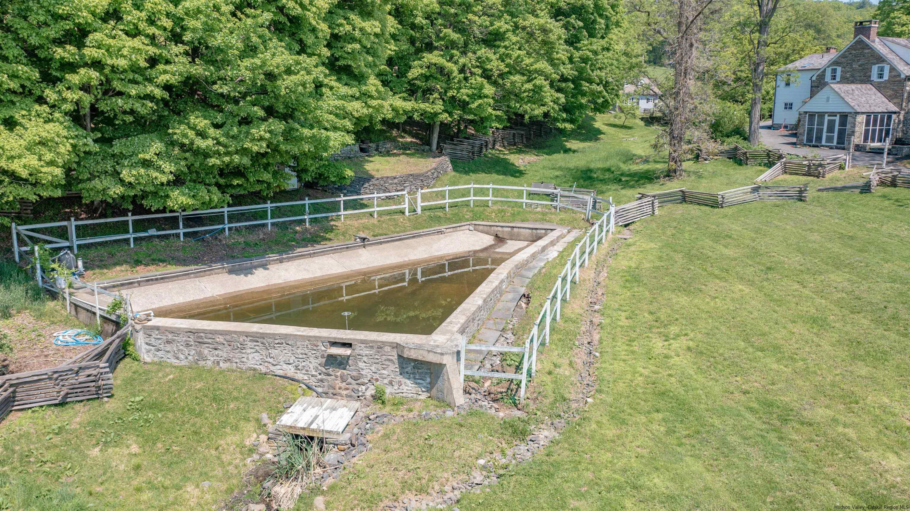 115 Buck Road Stone Ridge, NY 12484 - Photo 33 of 35 a view of a swimming pool with a garden and trees