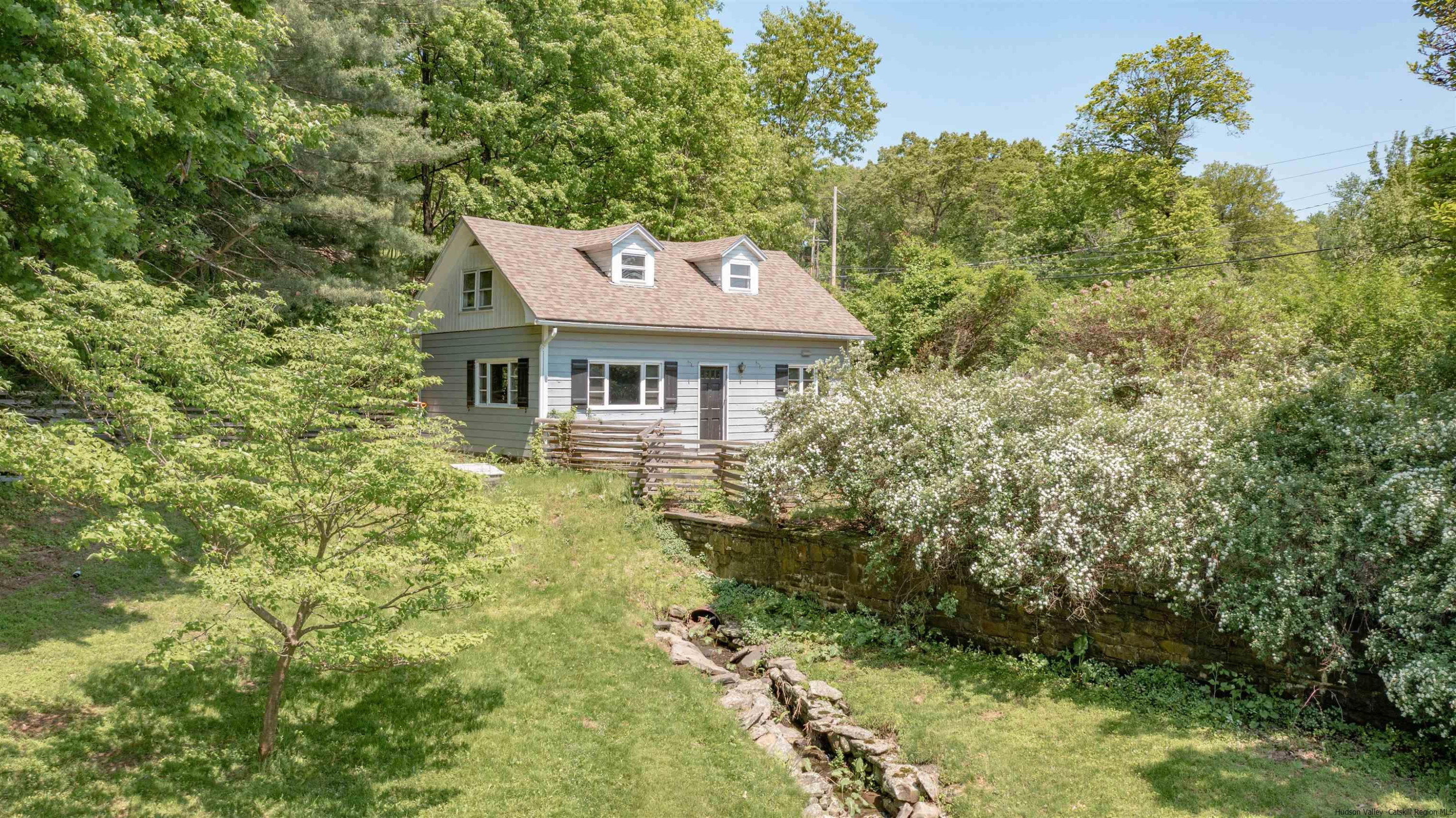 115 Buck Road Stone Ridge, NY 12484 - Photo 7 of 35 a aerial view of a house with a yard table and chairs
