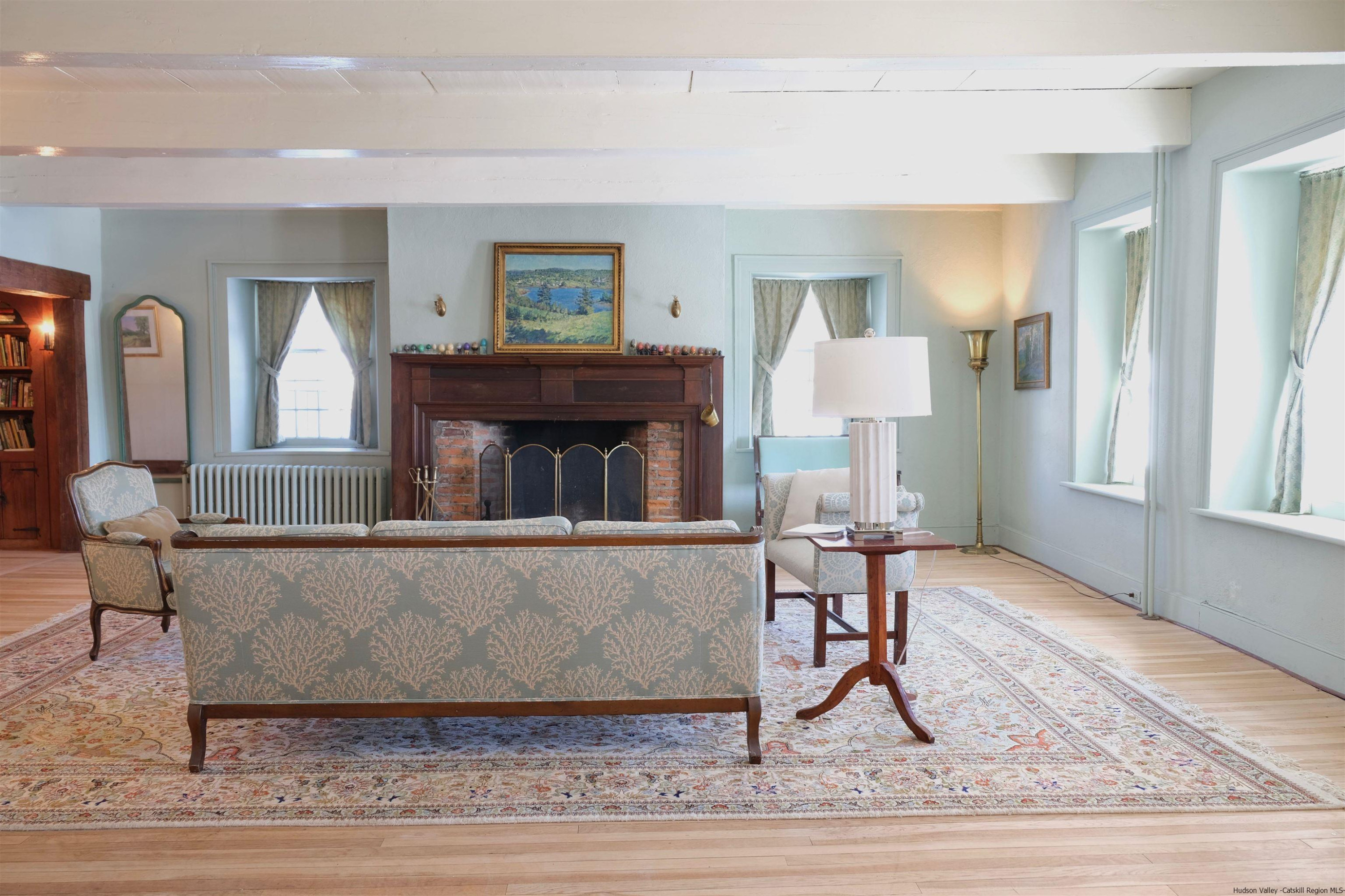 115 Buck Road Stone Ridge, NY 12484 - Photo 10 of 35 a living room with furniture and a wooden floor