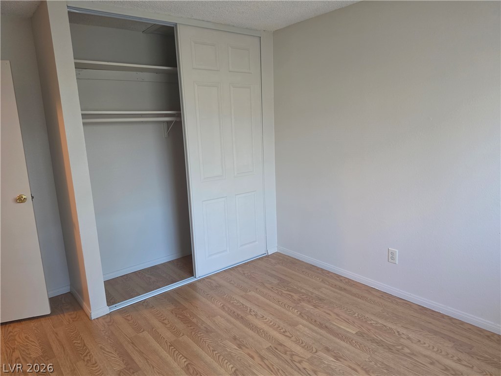 5289 Reeder Circle Las Vegas, NV 89119 - Photo 24 of 40 Warm wood flooring and a sliding closet door highlight this versatile secondary bedroom.