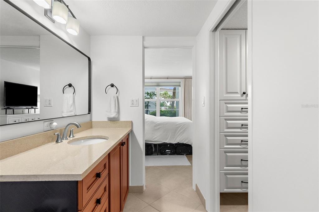 600 Sutton Place, Unit 101B Longboat Key, FL 34228 - Photo 16 of 53 a en suite bathroom with a sink and a mirror