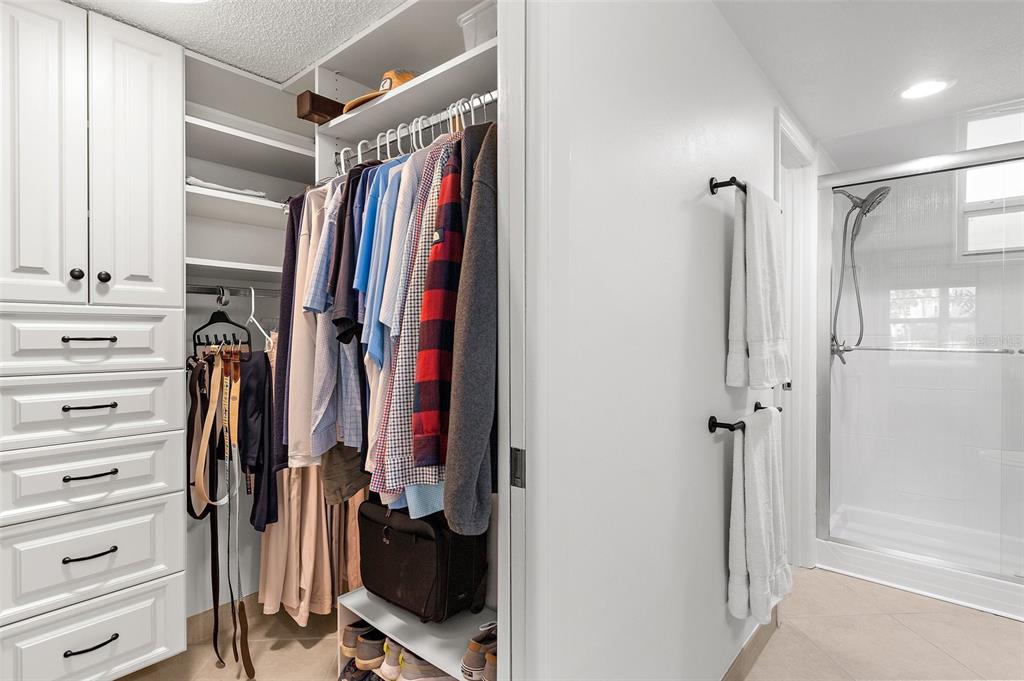 600 Sutton Place, Unit 101B Longboat Key, FL 34228 - Photo 17 of 53 a view of walk in closet with clothes