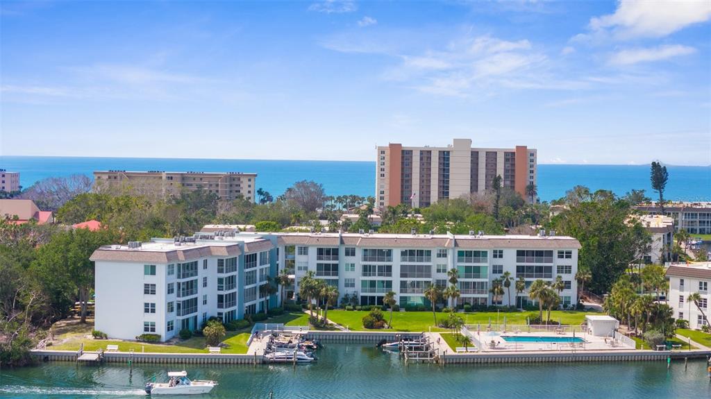 600 Sutton Place, Unit 101B Longboat Key, FL 34228 - Photo 26 of 53 a view of lake with building in front of it