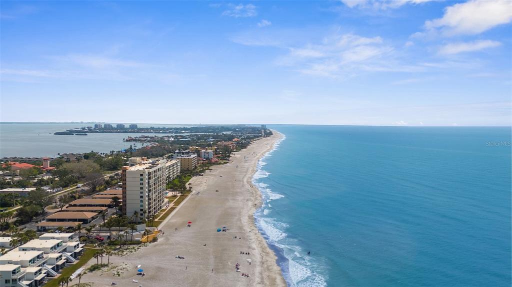 600 Sutton Place, Unit 101B Longboat Key, FL 34228 - Photo 3 of 53 a view of an ocean beach and city