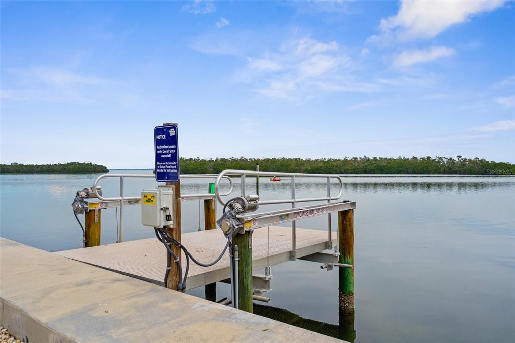600 Sutton Place, Unit 101B Longboat Key, FL 34228 - Photo 31 of 53 a view of a lake with a terrace