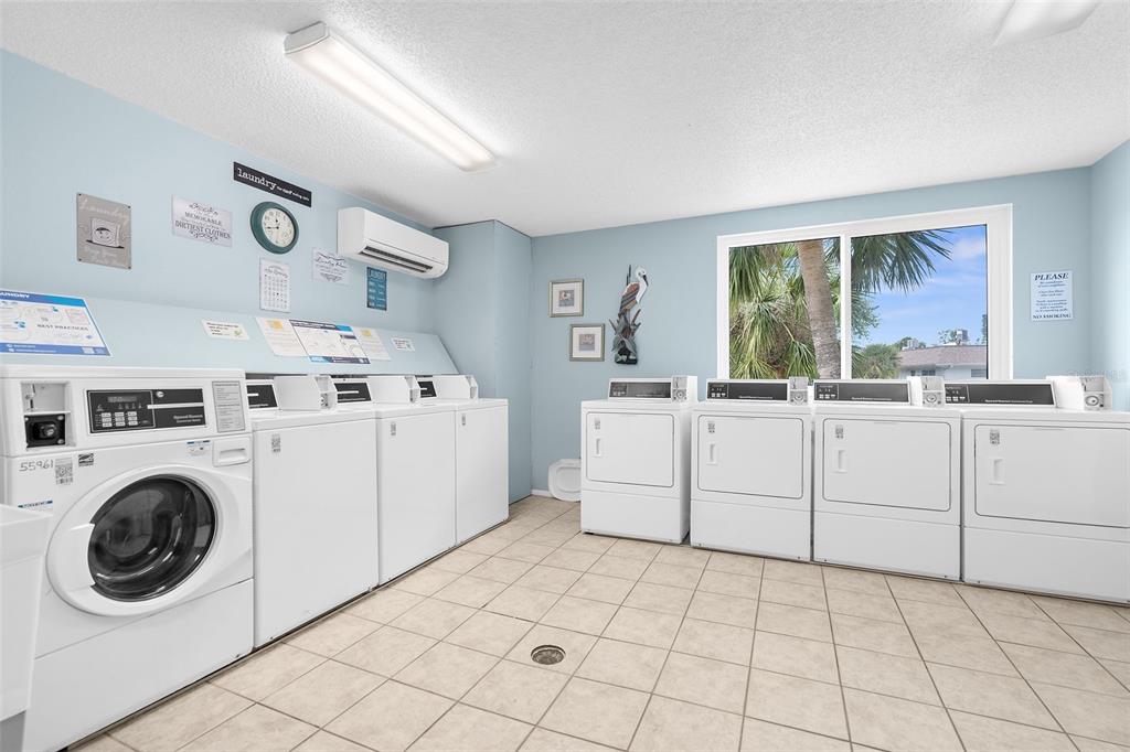 600 Sutton Place, Unit 101B Longboat Key, FL 34228 - Photo 32 of 53 a utility room with dryer and washer