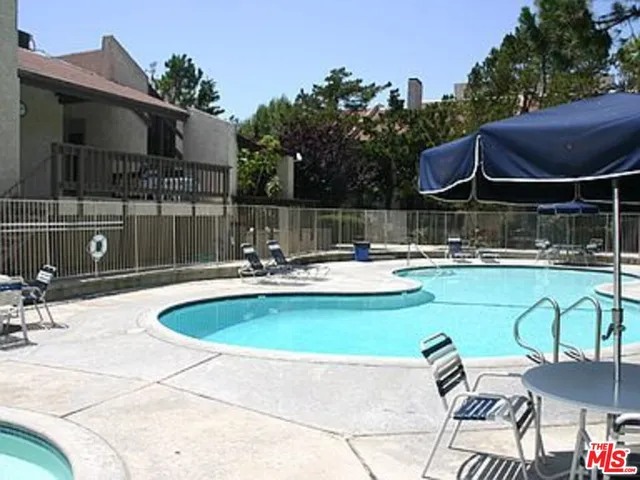 a swimming pool with outdoor seating and yard