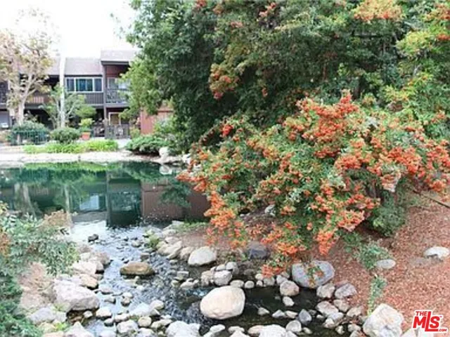 a view of a chair and table in backyard of the house