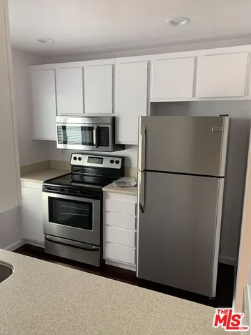 a kitchen with a refrigerator stove and microwave