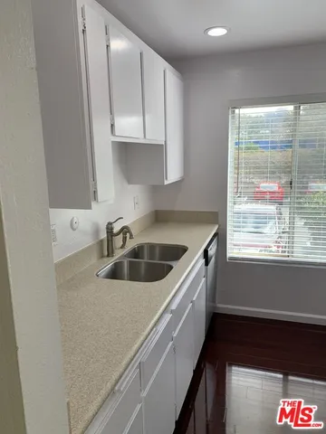 a kitchen with granite countertop a sink and a stove