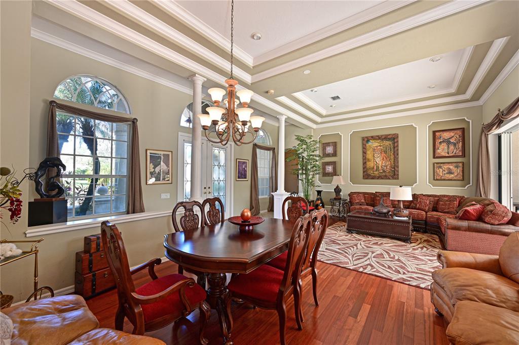 6602 Tallmast Circle Lakewood Ranch, FL 34202 - Photo 15 of 43 a living room with furniture a chandelier and a chandelier