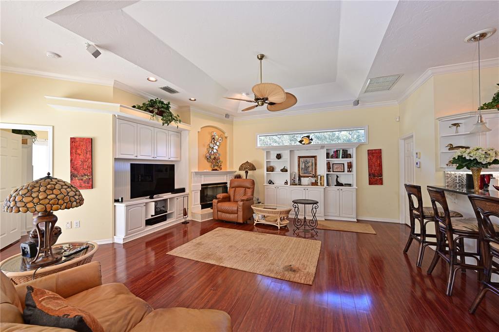 6602 Tallmast Circle Lakewood Ranch, FL 34202 - Photo 16 of 43 a living room with furniture a flat screen tv and a fireplace